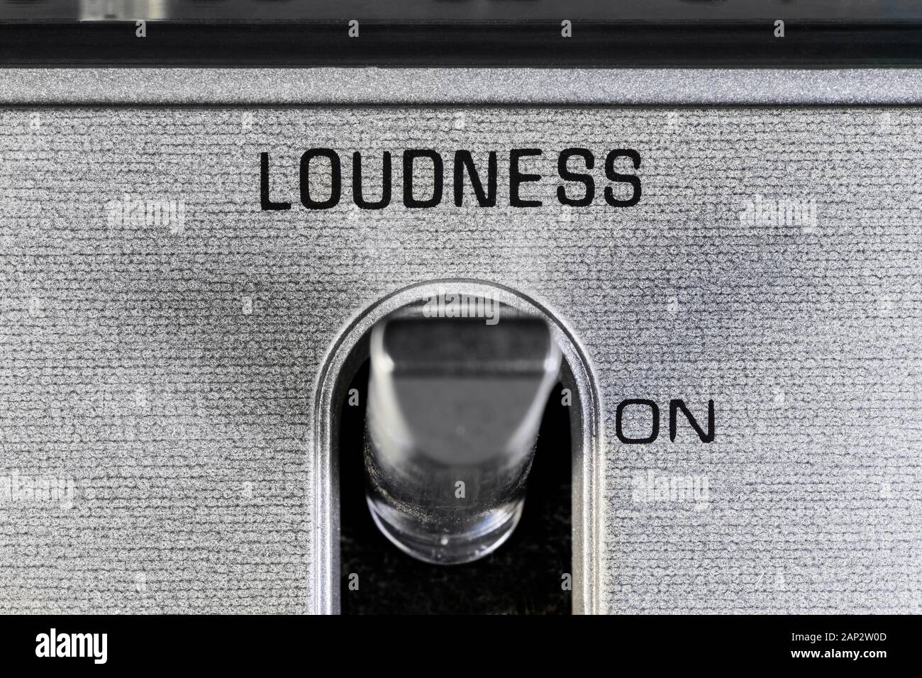 Close up macro photograph of loudness toggle switch detail on vintage boombox stereo. Stock Photo