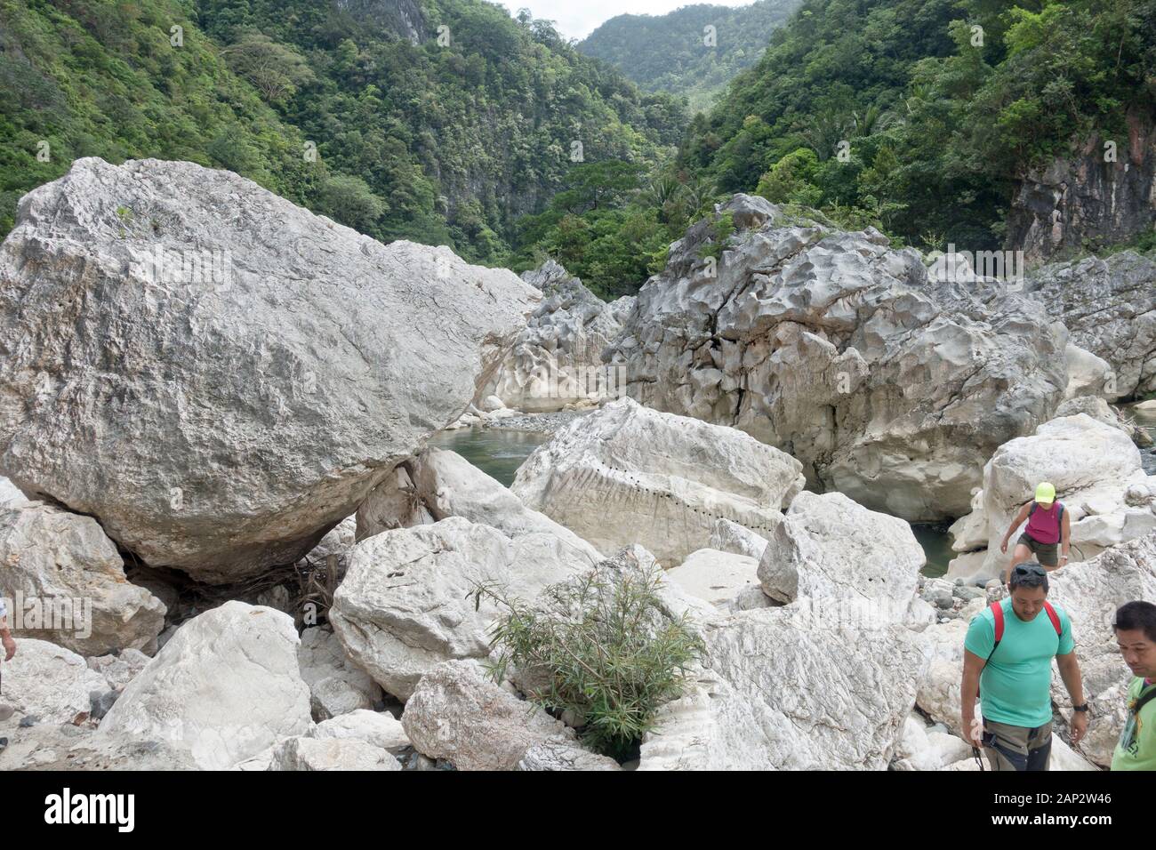 Tinipak River flows through mountainous terrain with rapids and cave with a natural swimming pool. Stock Photo