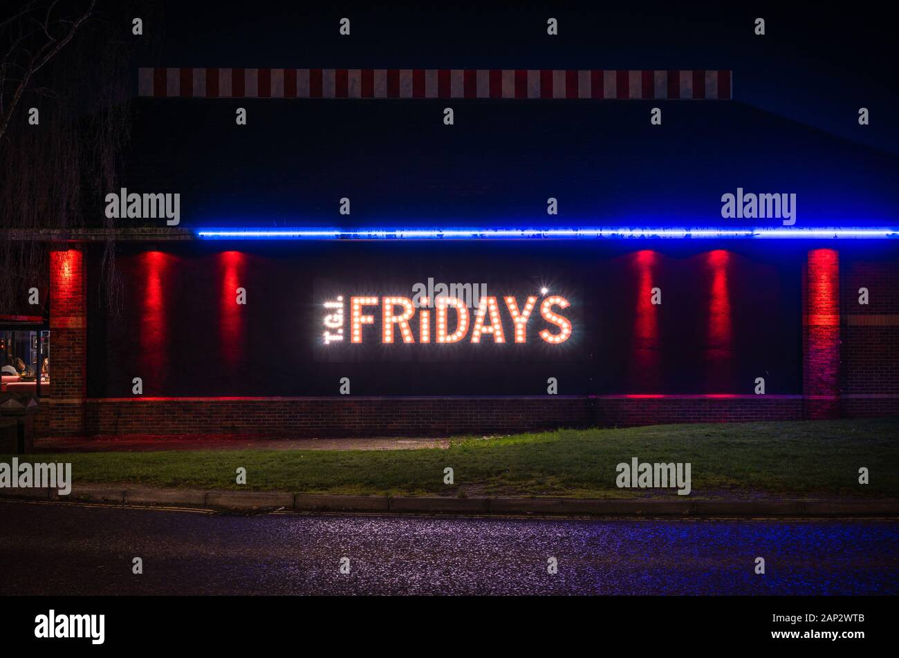 Illuminated sign on a TGI Friday's restaurant at night in Southampton 2020, England, UK Stock Photo
