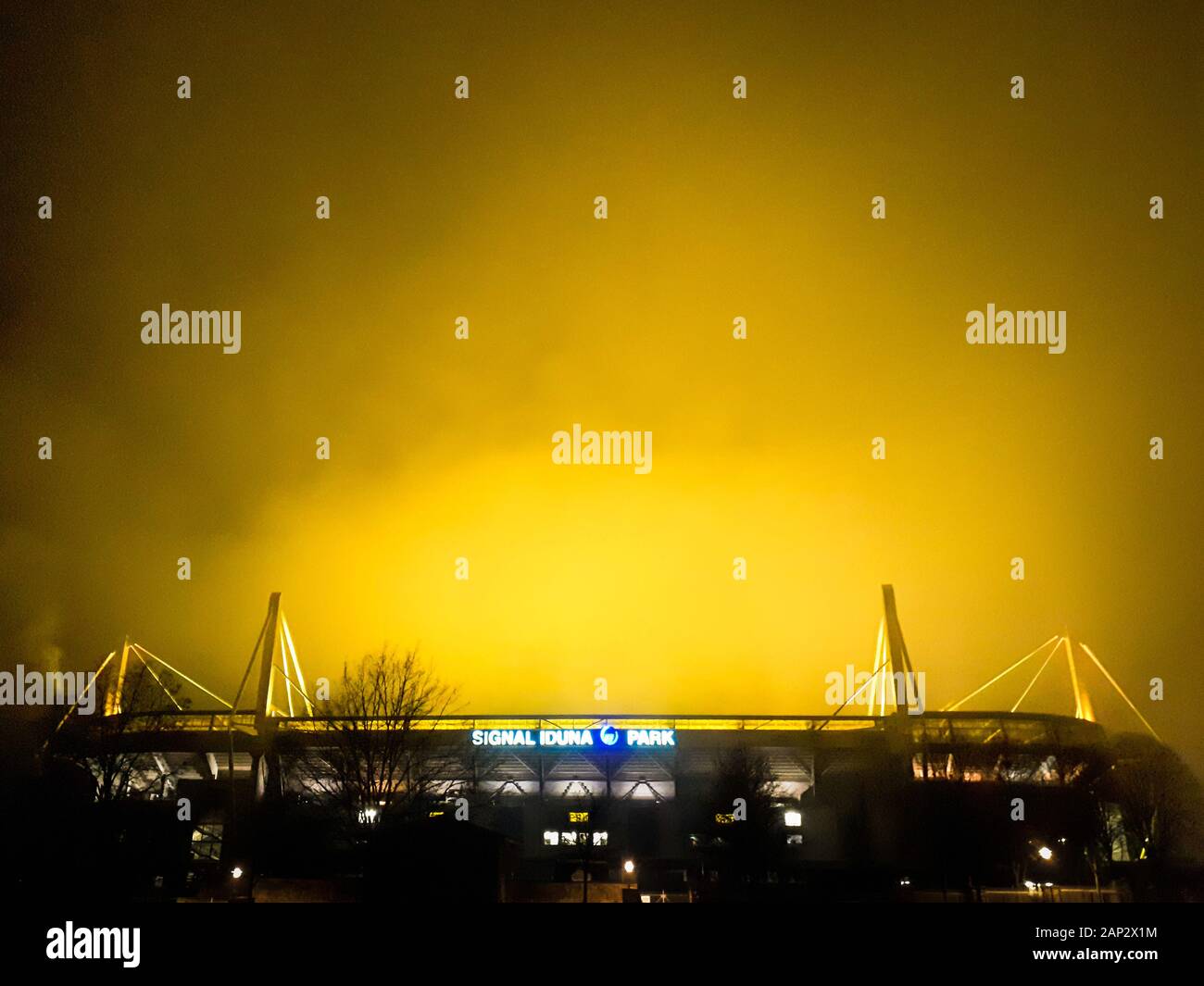 Dortmund, Germany, January 20, 2020: Signal Iduna Park (Westfalenstadion) at night. In the stadium of the Bundesliga club BvB Borussia Dortmund, the lawn is artificially illuminated at night, the light shines yellow in the evening sky.   ---   Dortmund, 20.1.2020: Signal Iduna Park (Westfalenstadion) bei Nacht. Im Stadion des Bundesligavereins BvB Borussia Dortmund wird nachts der Rasen künstlich beleuchtet, das Licht strahlt gelb in den Abendhimmel. Stock Photo