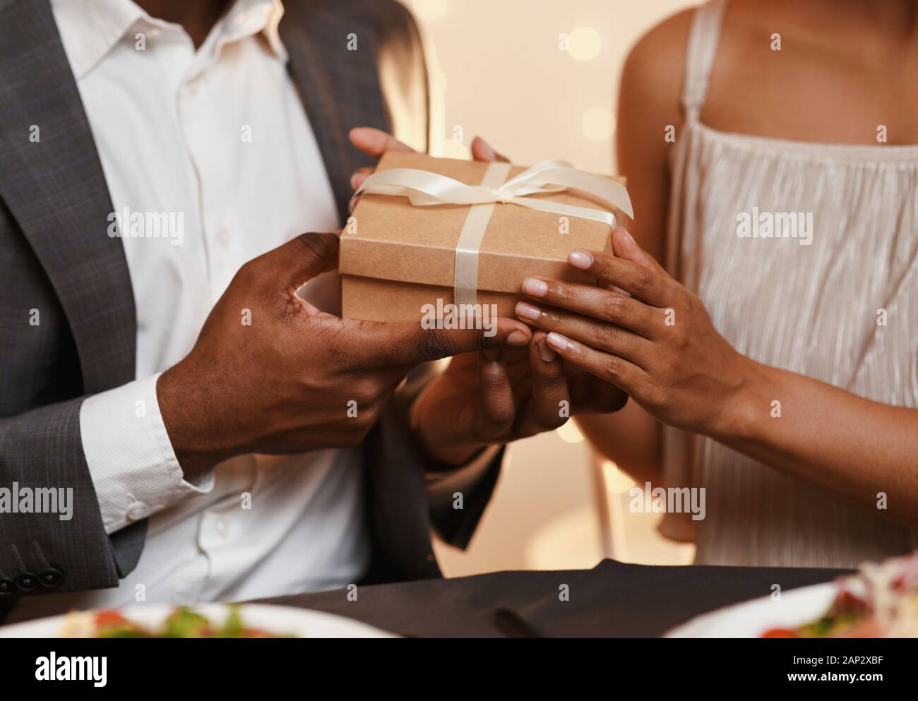 Cropped of man and woman holding gift box Stock Photo