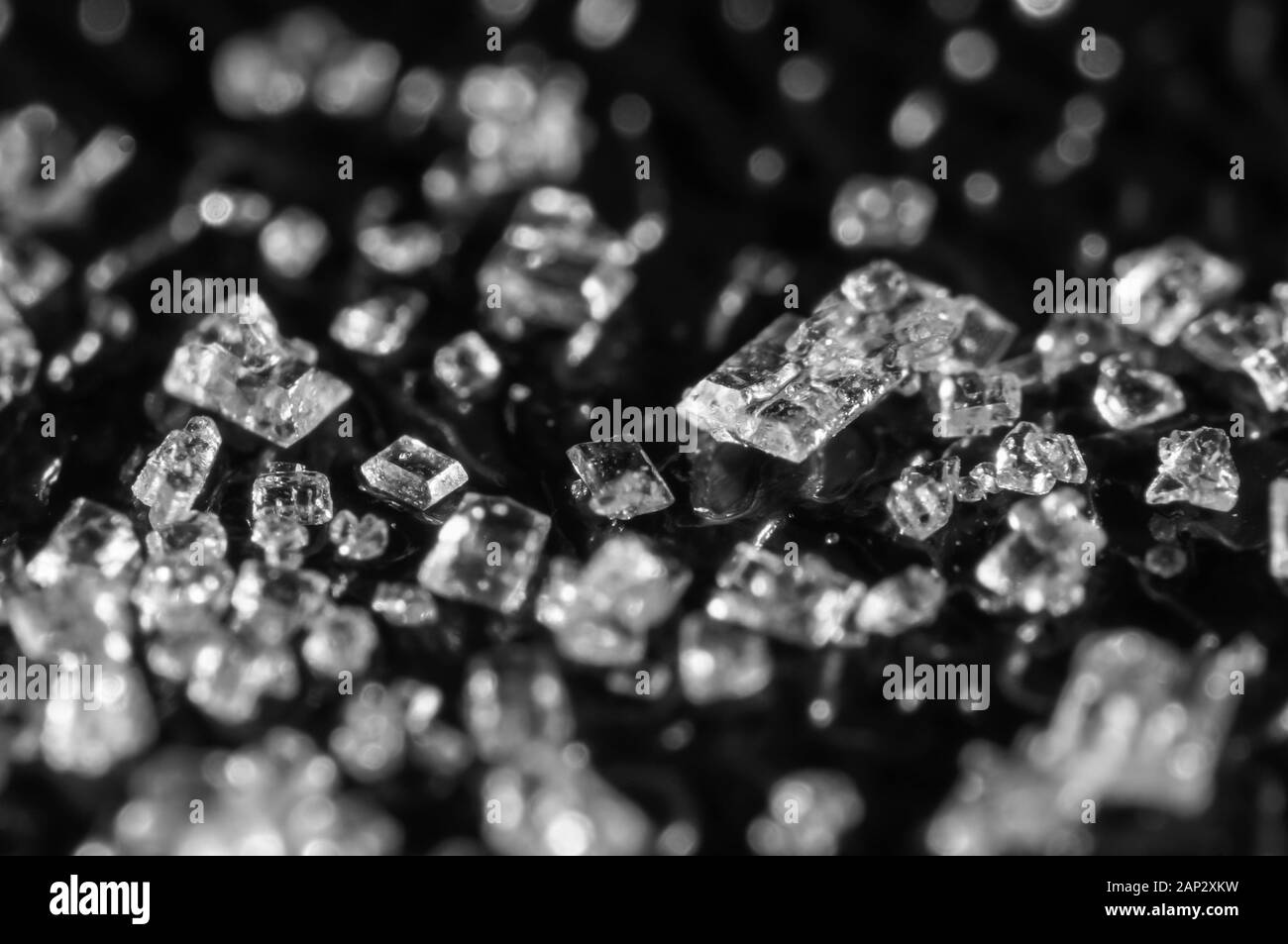 Sugar crystals on a black background. Super Macro. Soft Focus, shallow depth of field.black and white image. Stock Photo