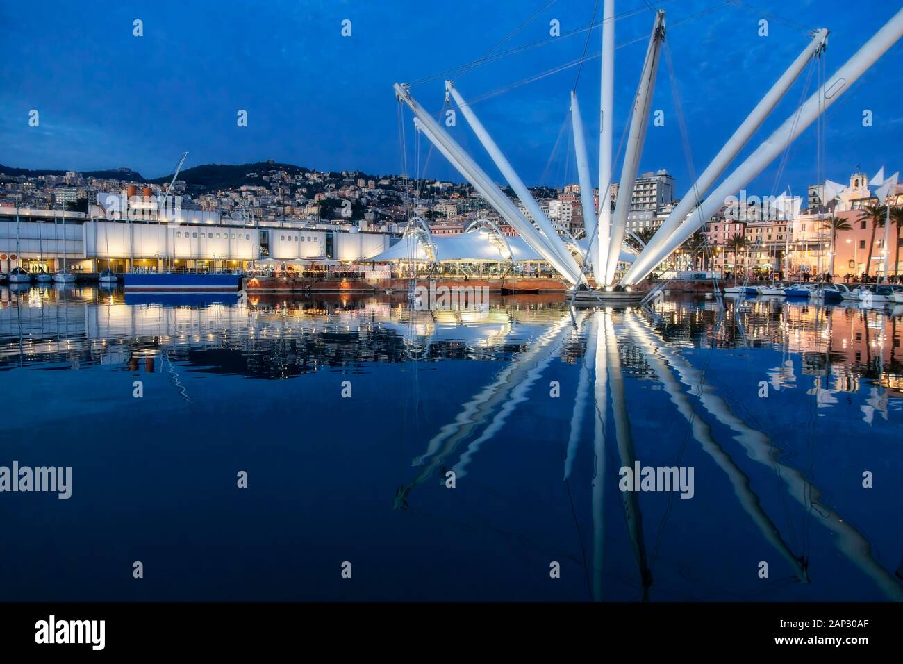 Evening view of the Bigo structure in the old port of Genoa, Italy, with the reflection of the arms of the building in calm water surface Stock Photo