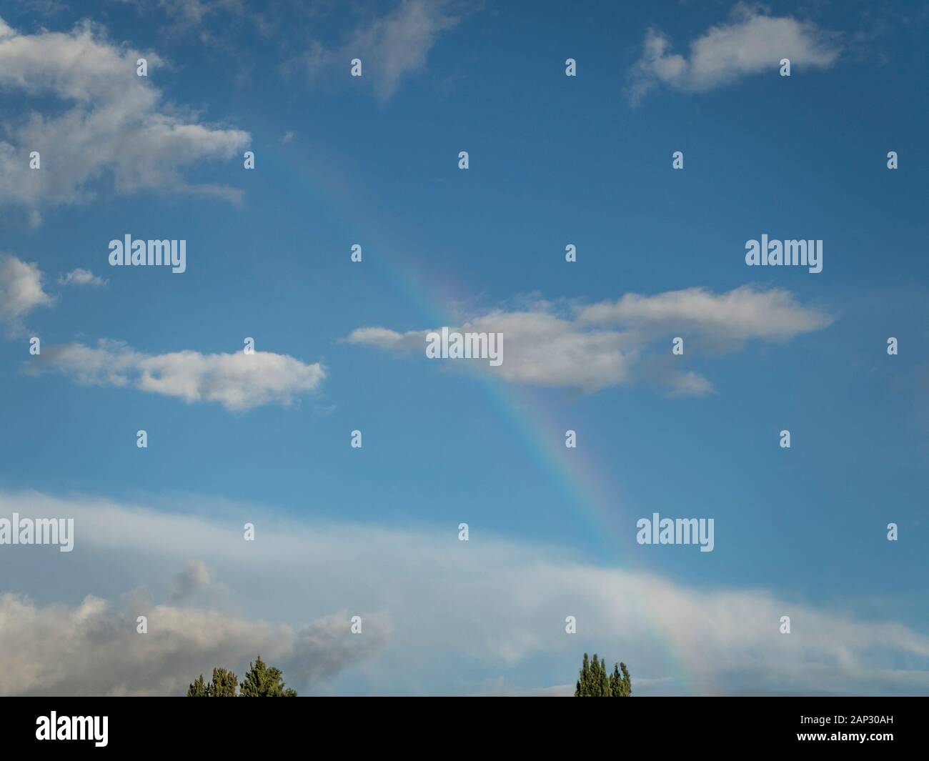 Rainbow against dark clouds hi-res stock photography and images - Alamy