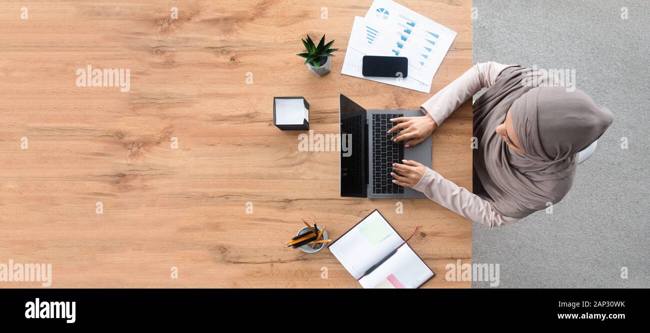 Top view of islamic woman working on laptop at workplace Stock Photo ...