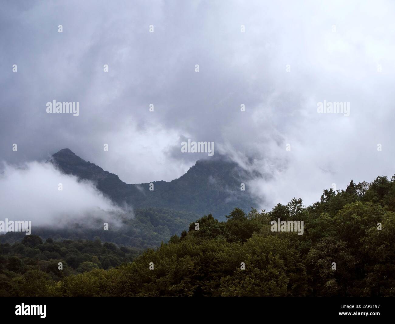Mountains shrouded in clouds Stock Photo - Alamy