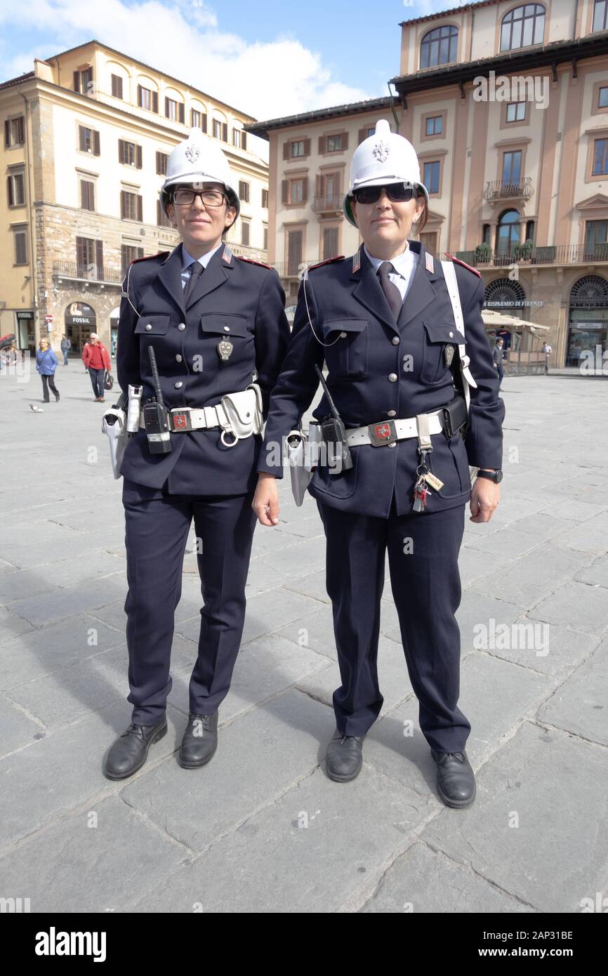 Police smiling into camera in Piazza della Signoria. L-shaped square in front of the Palazzo Vecchio in Florence, Italy. Stock Photo