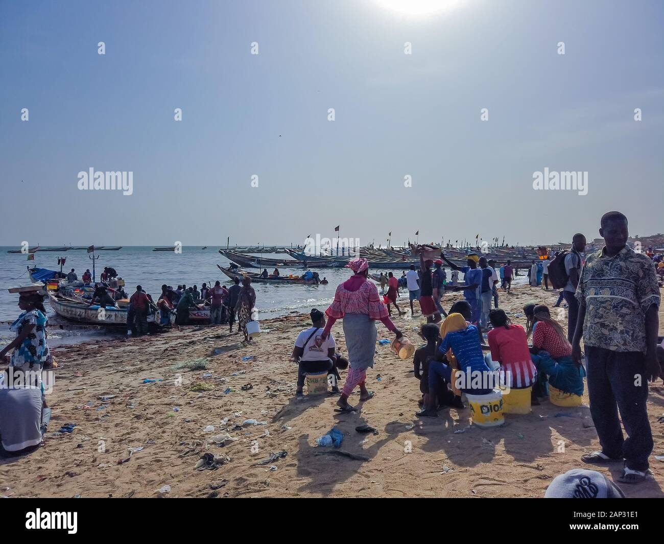 MBour, Senegal- April 25 2019: Unidentified Senegalese men and women at the fish market in the port city near Dakar. There are stalls selling and Stock Photo