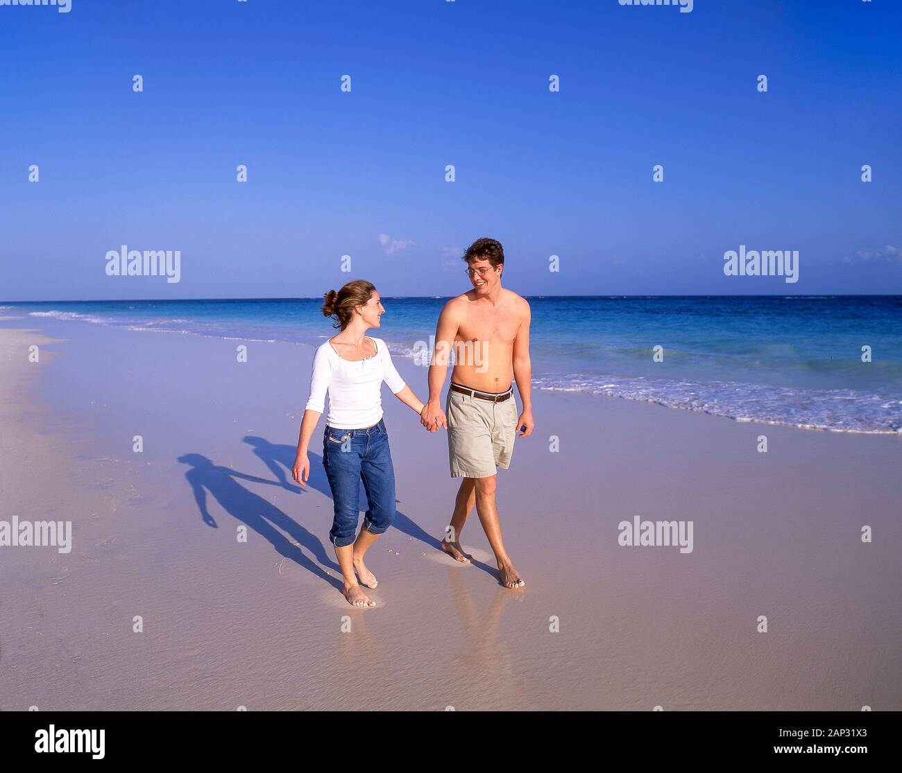 Young couple walking on beach, South Shore, Warwick Parish, Bermuda Stock Photo