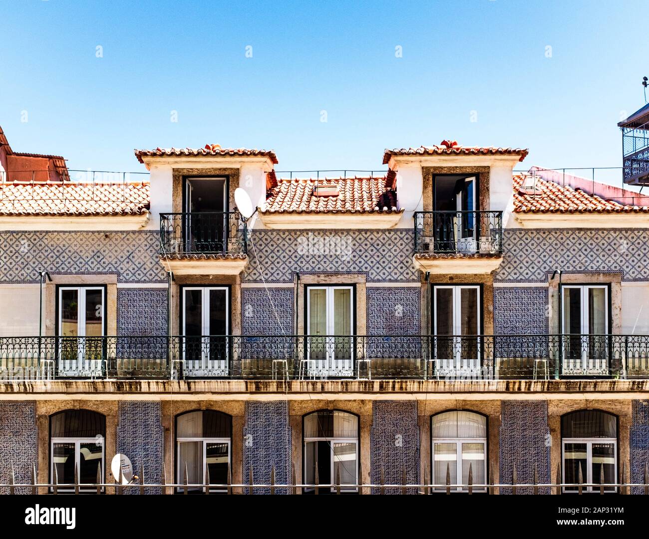 Traditional Lisbon dwelling house with tile decoration and balconies. Stock Photo