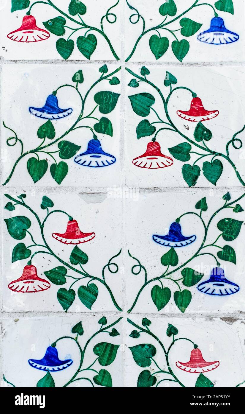 Portuguese traditional tiles Azulejos with blue and red floral pattern on a white background. Stock Photo