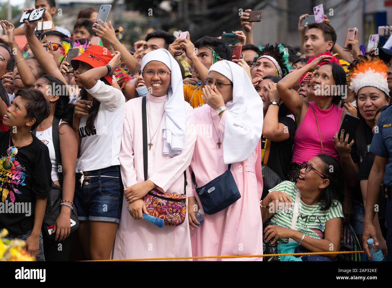 Two nuns within a large crowd of people taking photographs or video with  their mobile phones during the Sinulog Festival,Cebu City,Philippines Stock  Photo - Alamy