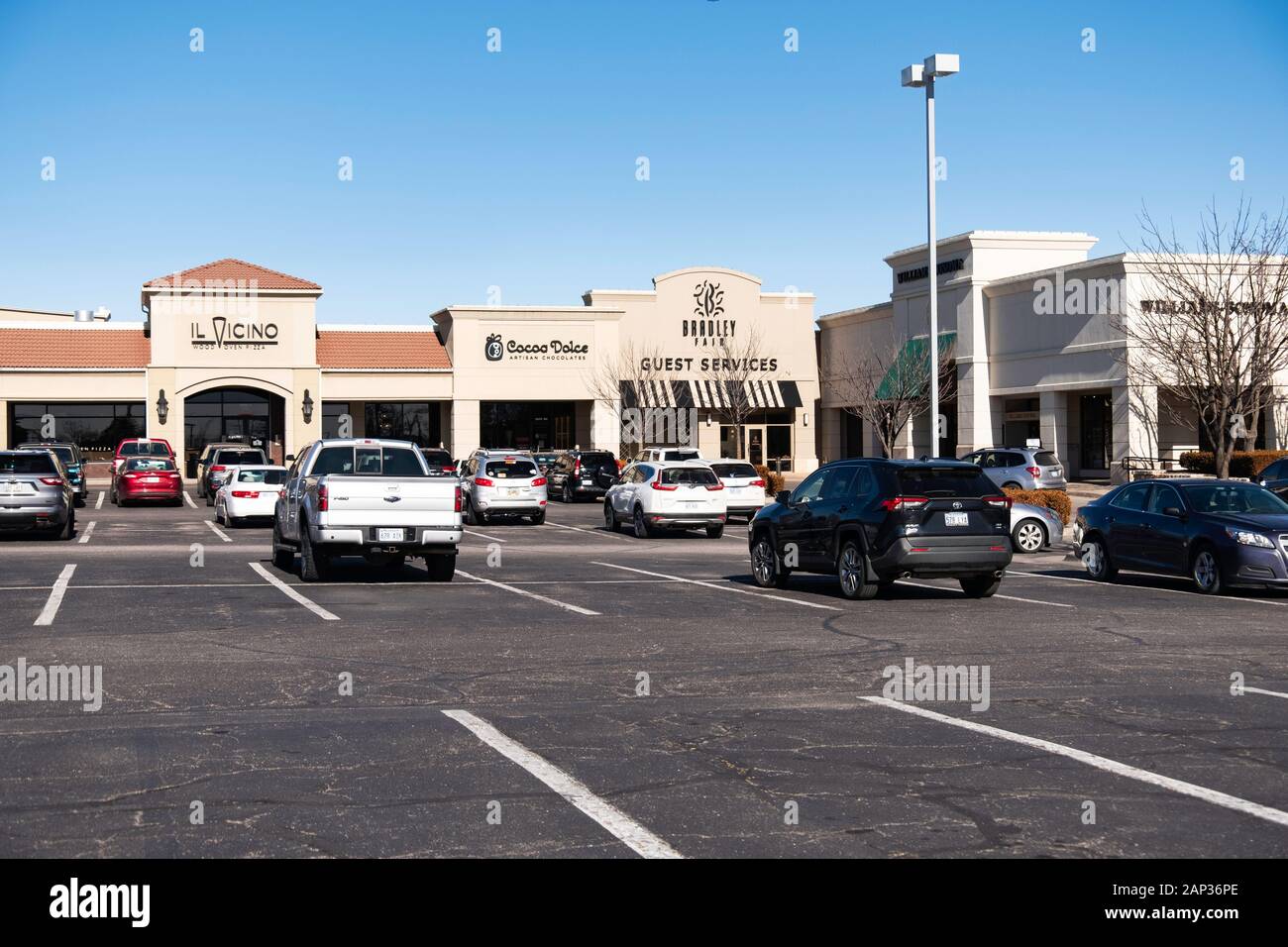 Bradley Fair shopping center in Wichita, Kansas, USA. Parking lot, chocolate shop and pizzeria. Stock Photo