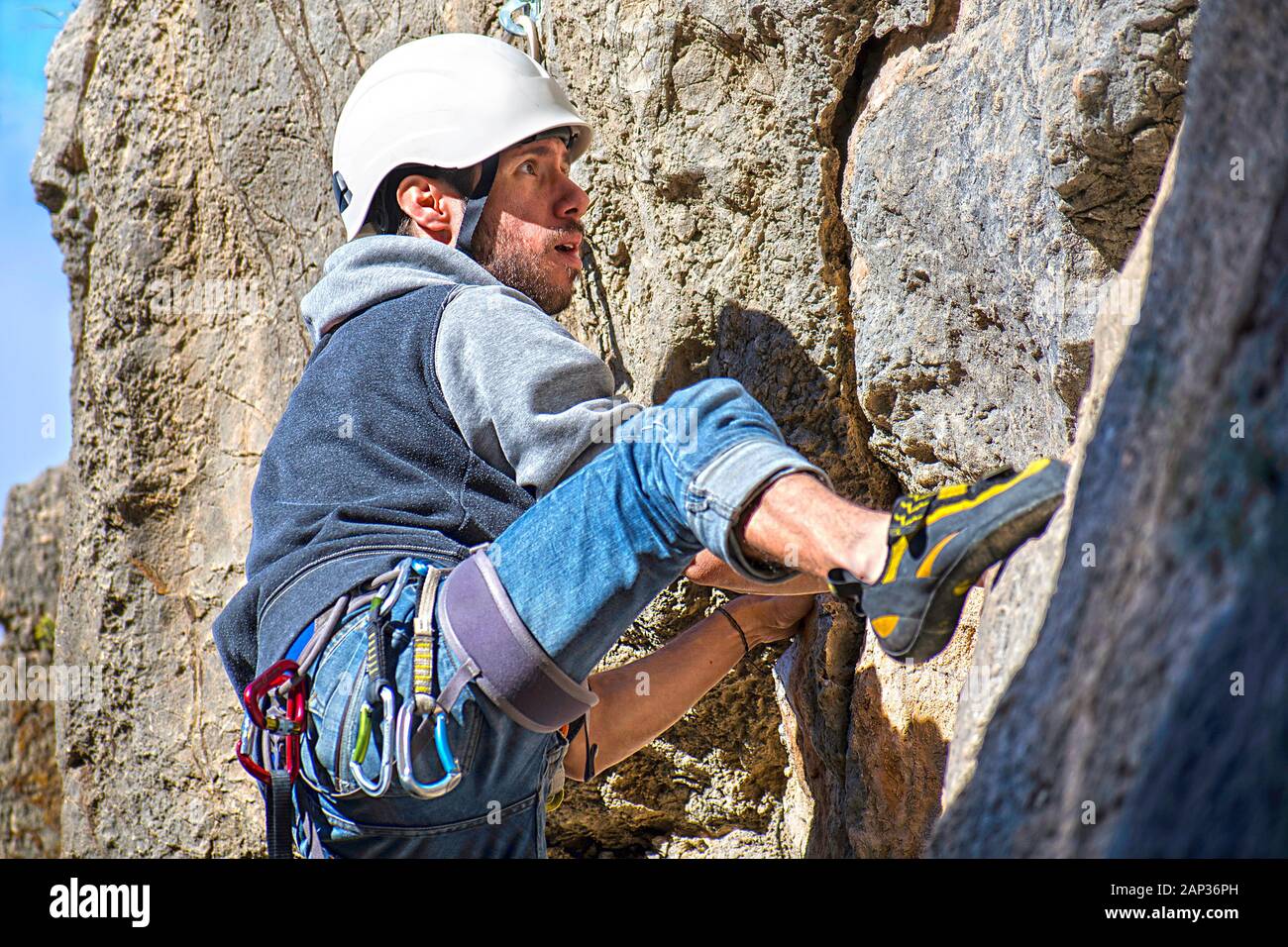 One sportsman mountain climbing. Physical activity in the countryside. Risky sports. Mountain climb or climbing is a dangerous exercise that needs saf Stock Photo