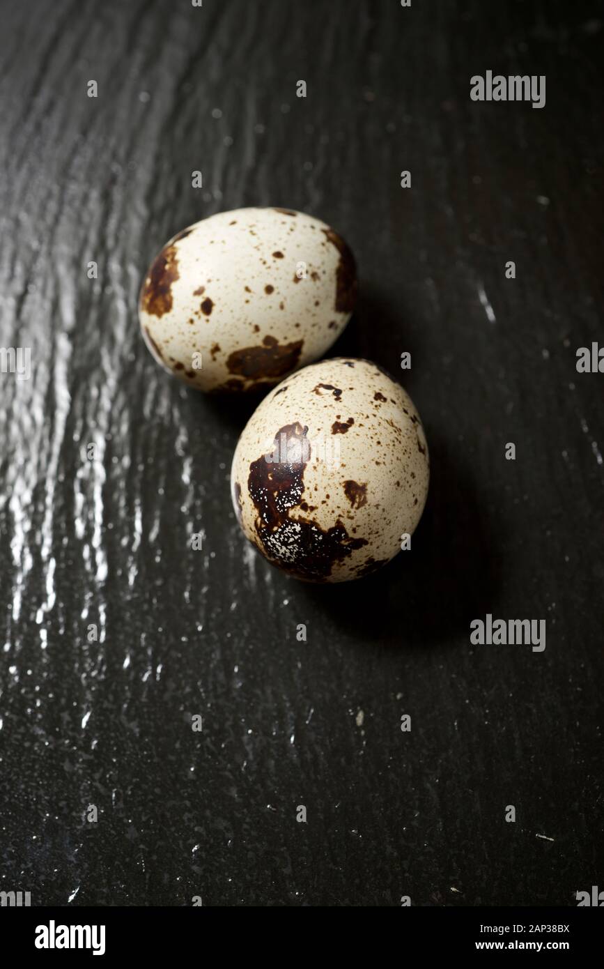 Quail eggs on a black table. Stock Photo