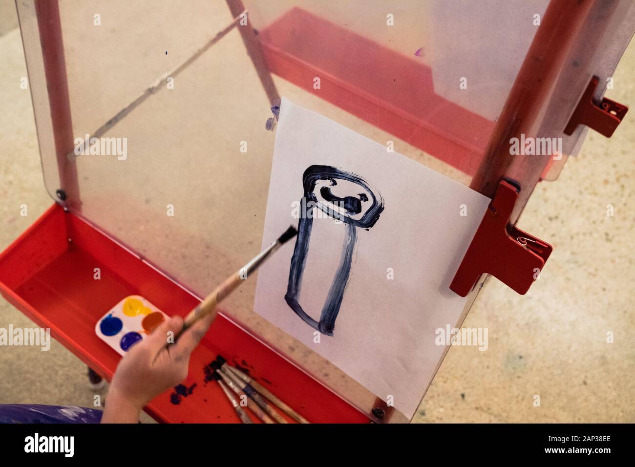 child painting a portrait of a person in an art studio Stock Photo
