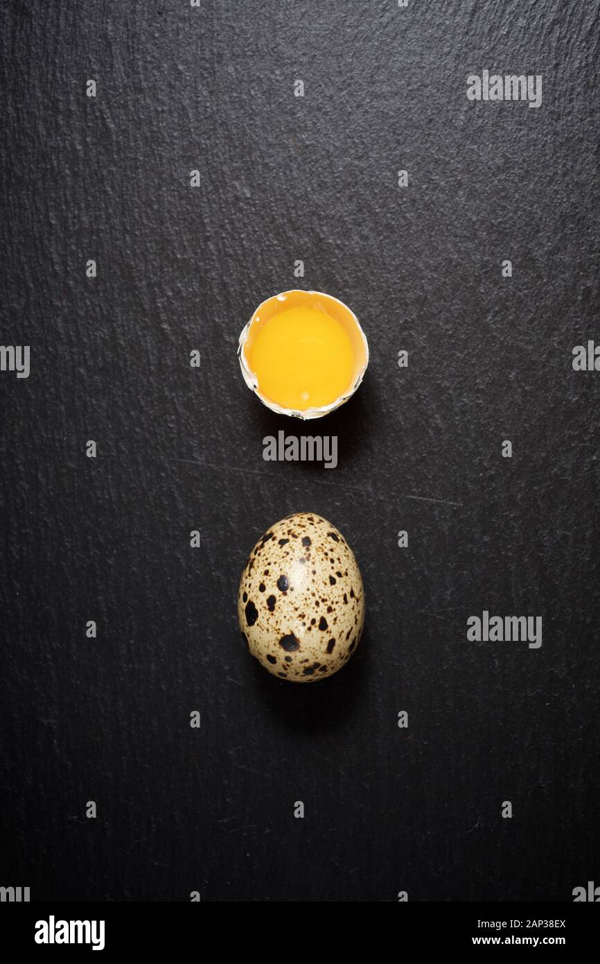 Quail eggs on a black table. Stock Photo