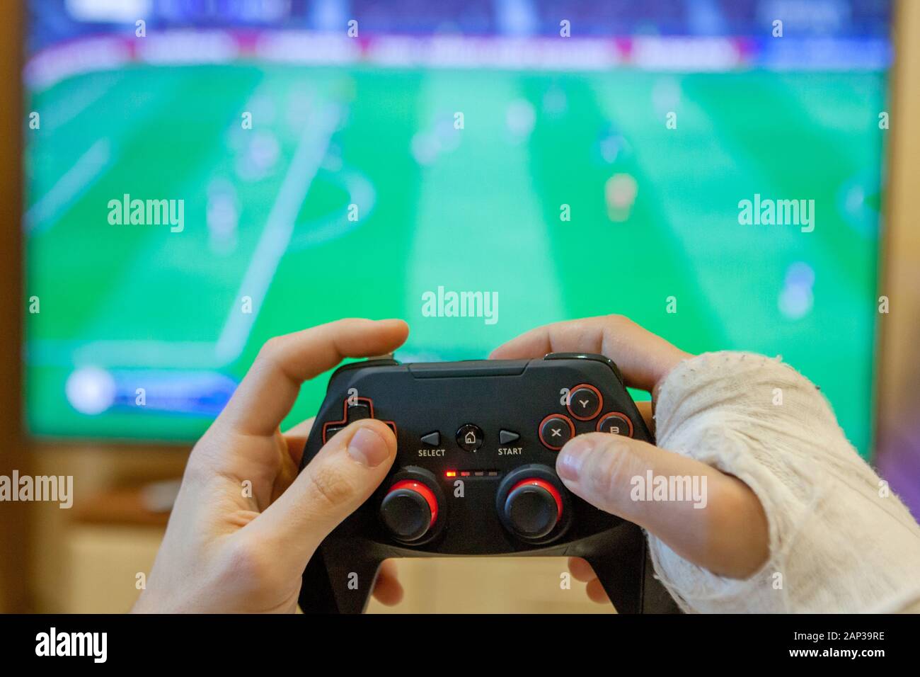 The broken hand of a boy holds in his hands a gamepad. Gaming game play tv  fun gamer gamepad guy controller video console playing player holding hobby  Stock Photo - Alamy