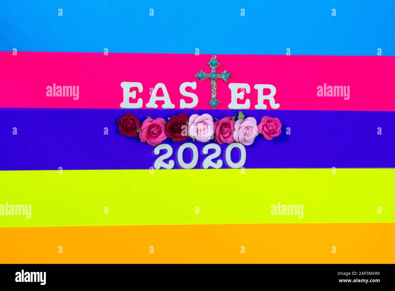 Multi colored bcakground with cross and flowers with the words Easter 2020, horizontal Stock Photo