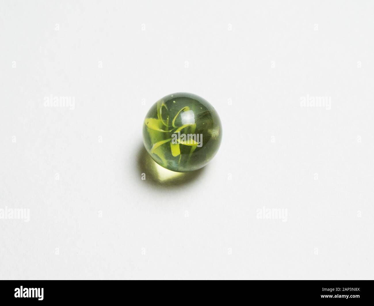 One green glass ball with caustic on white background Stock Photo Alamy