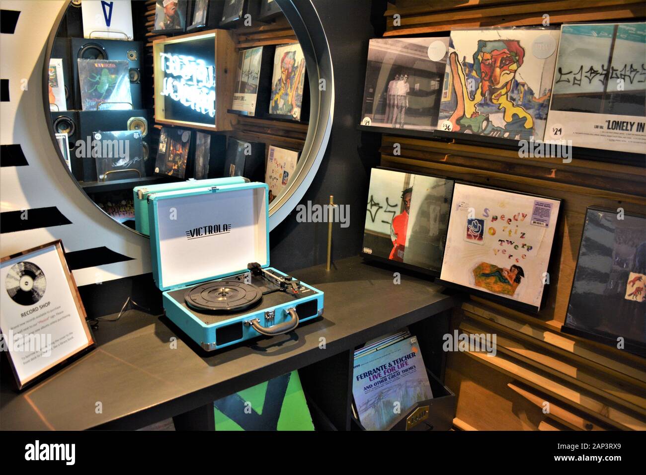 Old time portable record player and vinyl records for sale as retro and collectors items in high end hotel in Santa Barbara California Stock Photo