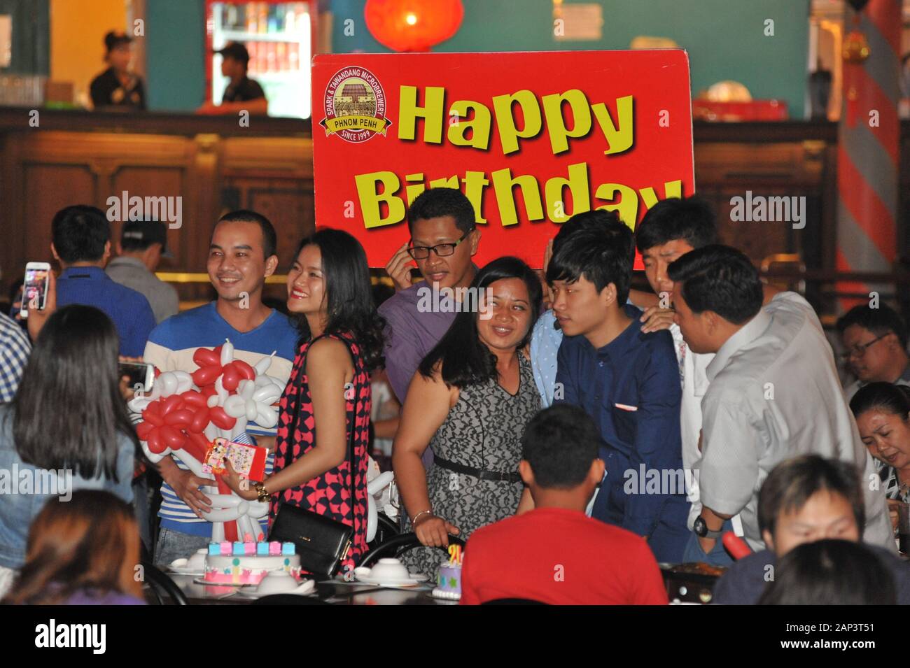 Cambodian Birthday Party w/ sign, Spark & Tawandang German Brewery, Phnom Penh, Cambodia, Indochina © Kraig Lieb Stock Photo