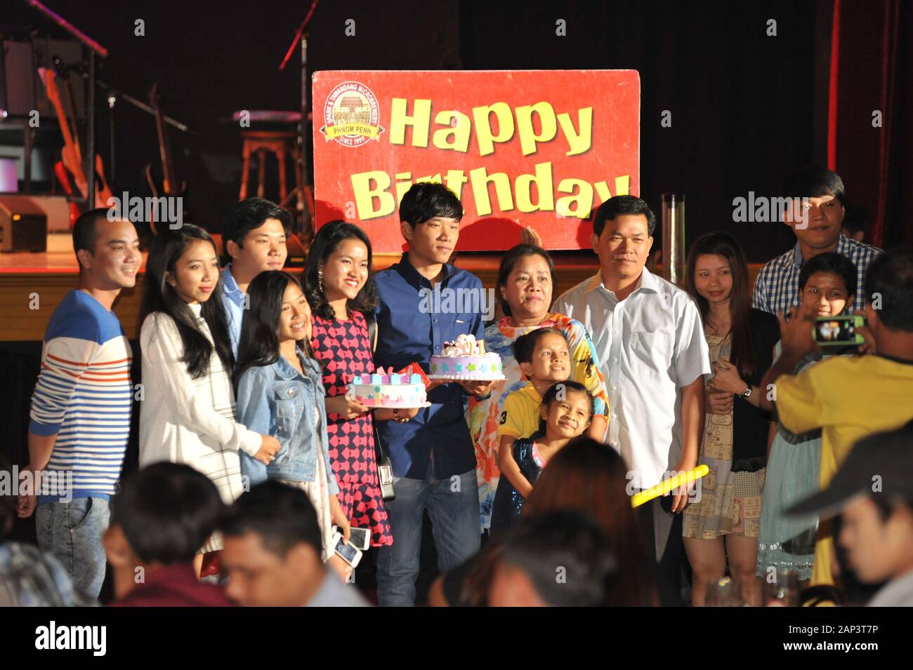 Cambodian Birthday Party w/ birthday cakes & sign, Spark & Tawandang German Brewery, Phnom Penh, Cambodia, Indochina © Kraig Lieb Stock Photo