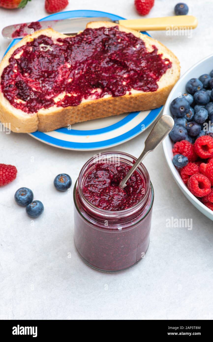Jar of homemade chia seed berry jam with bread and fruit Stock Photo ...
