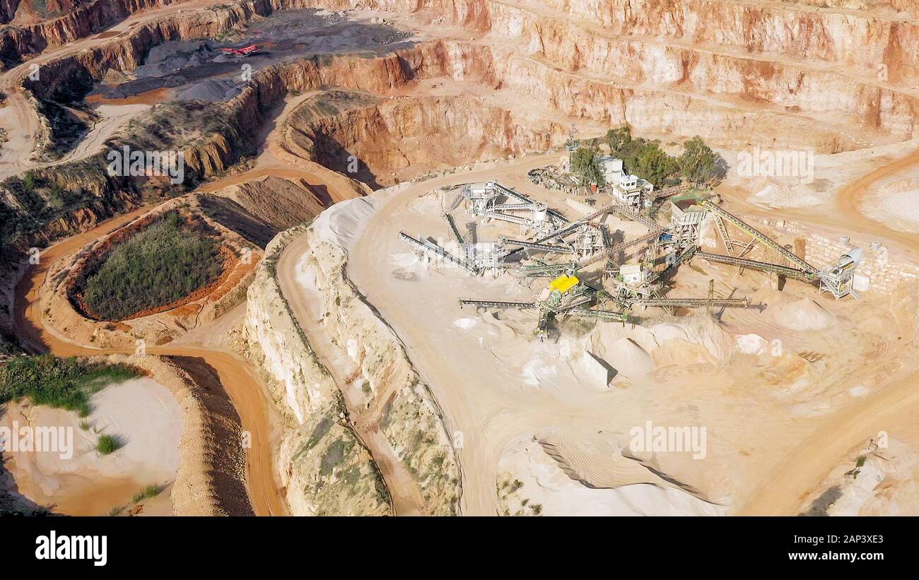 Aerial view of a large Quarry during work hours with Stone sorting conveyor belts Stock Photo