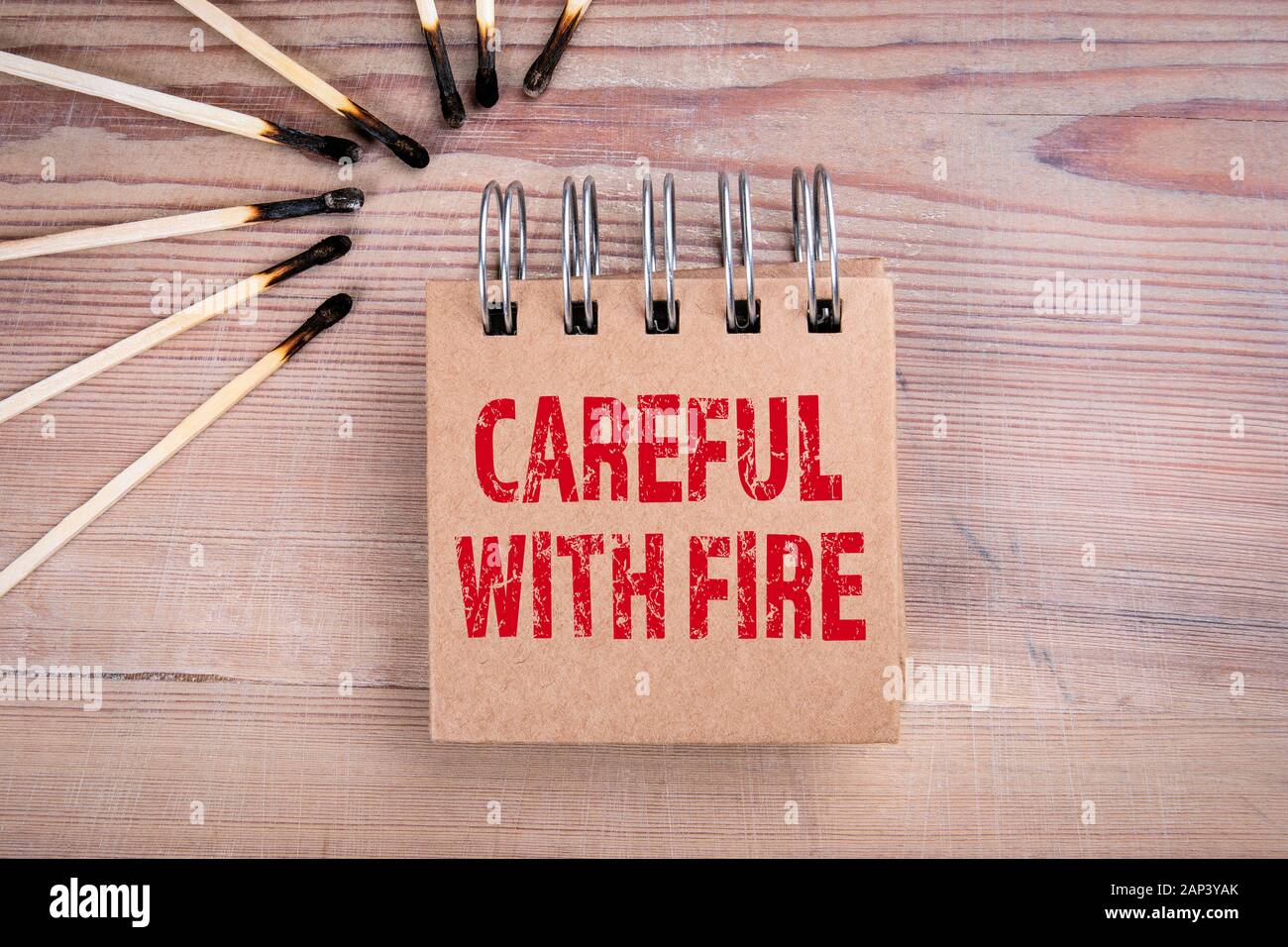 Careful with fire. Fire safety, nature, housing and human behavior concept. Burned matches on wood texture background Stock Photo