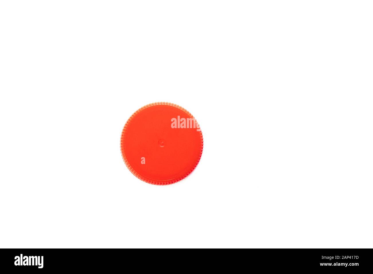 Red plastic bottle cap isolated on white background. Top view. Stock Photo