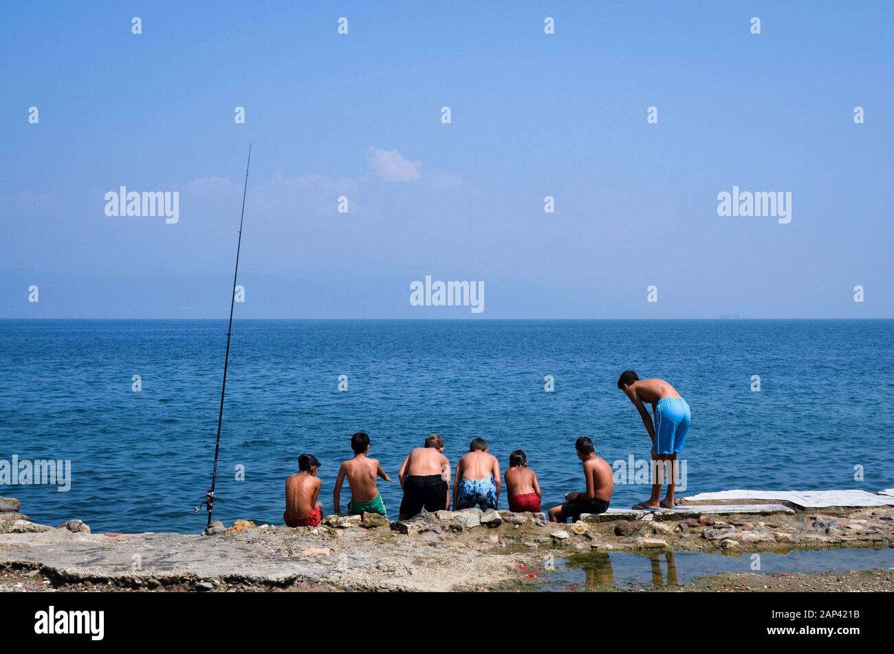 Kids are swimming and fishing on the beach, in Mudanya district of Turkey's Bursa province. Stock Photo