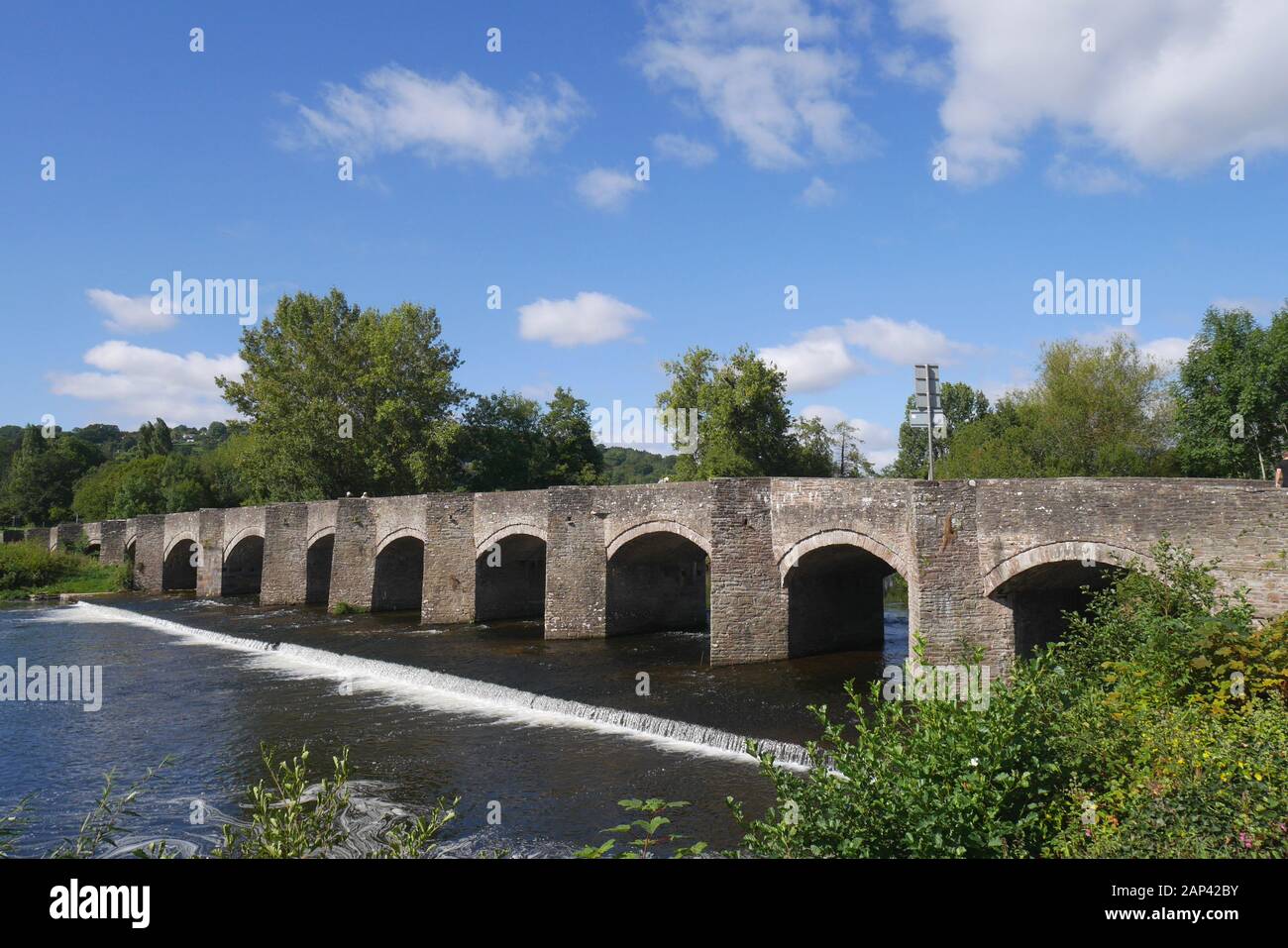 The grade 1 Listed 18th century bridge, standing above a weir, across the river Usk, in Crickhowell, Powys, Wales, United Kingdom Stock Photo