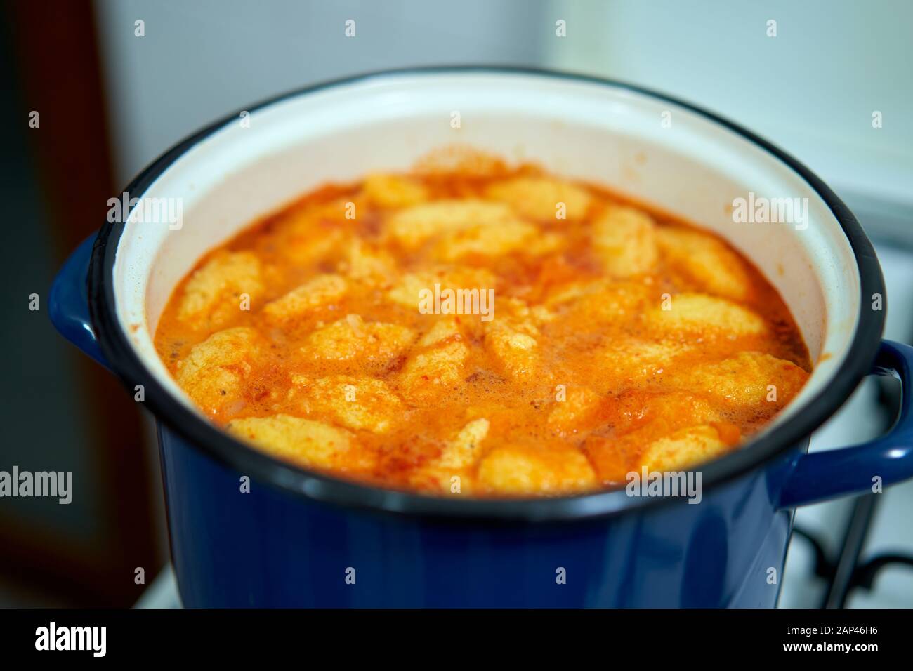 Cooking a soup with egg dumplings in a pot Stock Photo Alamy