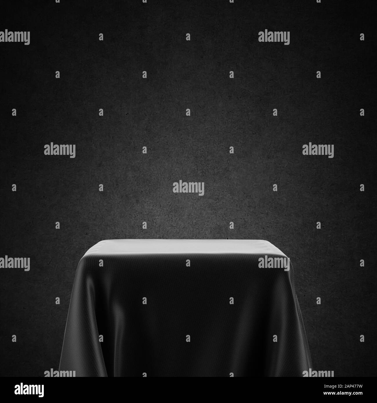 Black and white empty table, spotlight pedestal covered with cloth isolated on backlit background Stock Photo