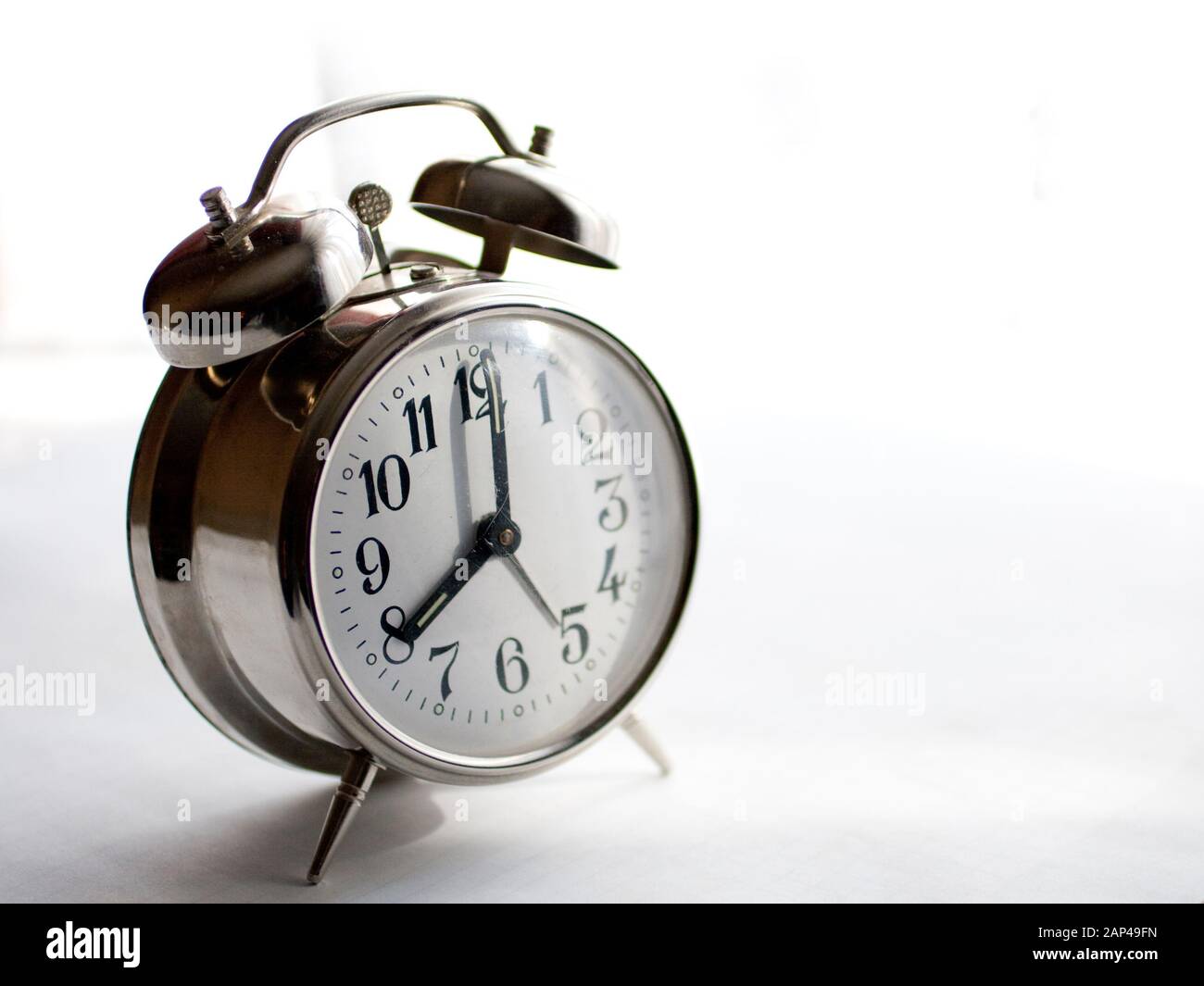 Vintage alarm clock isolated on white background Stock Photo - Alamy