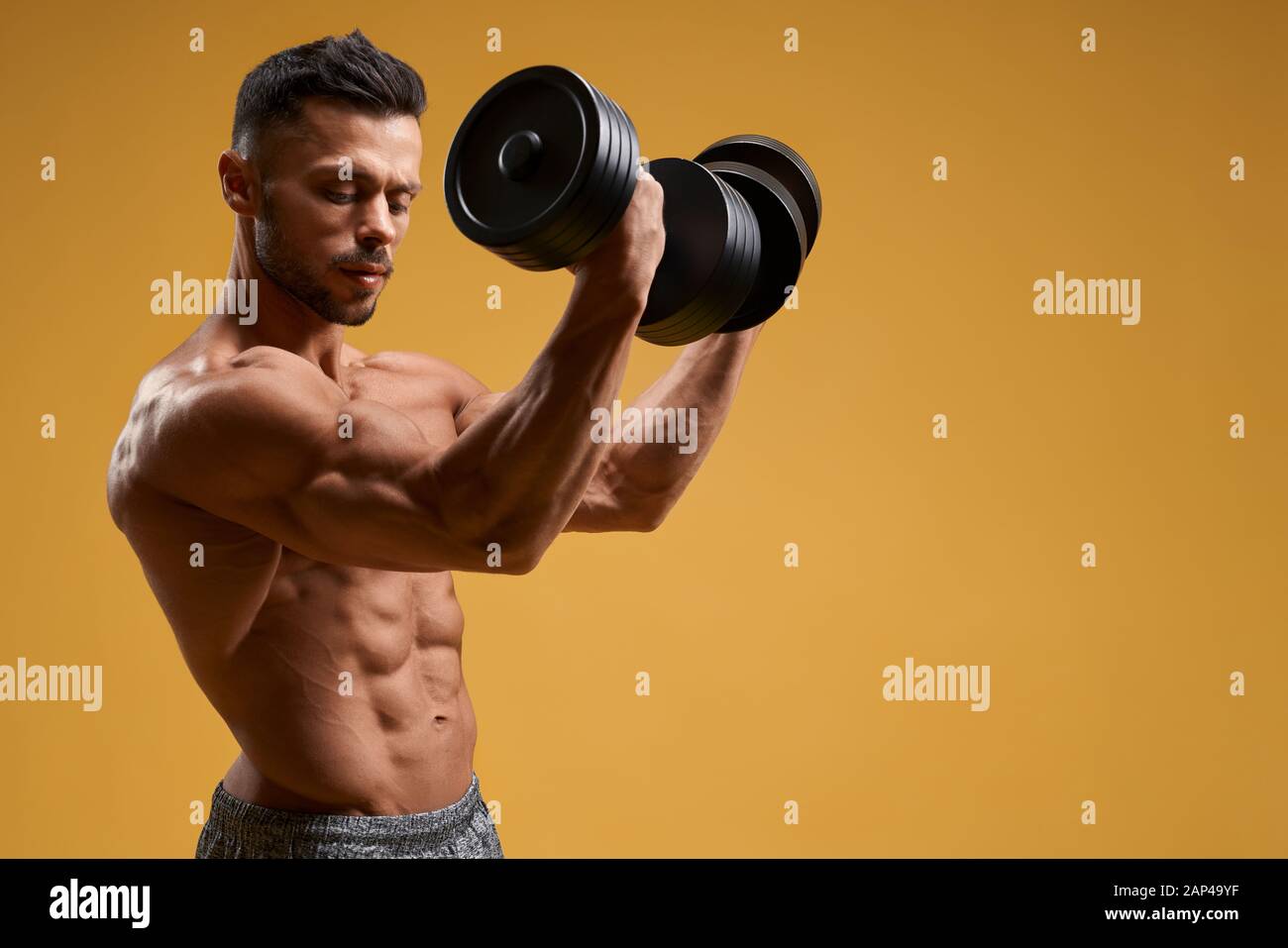 Handsome Muscular Fitness Bodybuilder Doing Heavy Weight Exercise