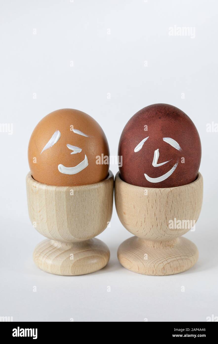 Painted and raw eggs. Funny drawings on eggshells. Easter artistic decoration. Stock Photo