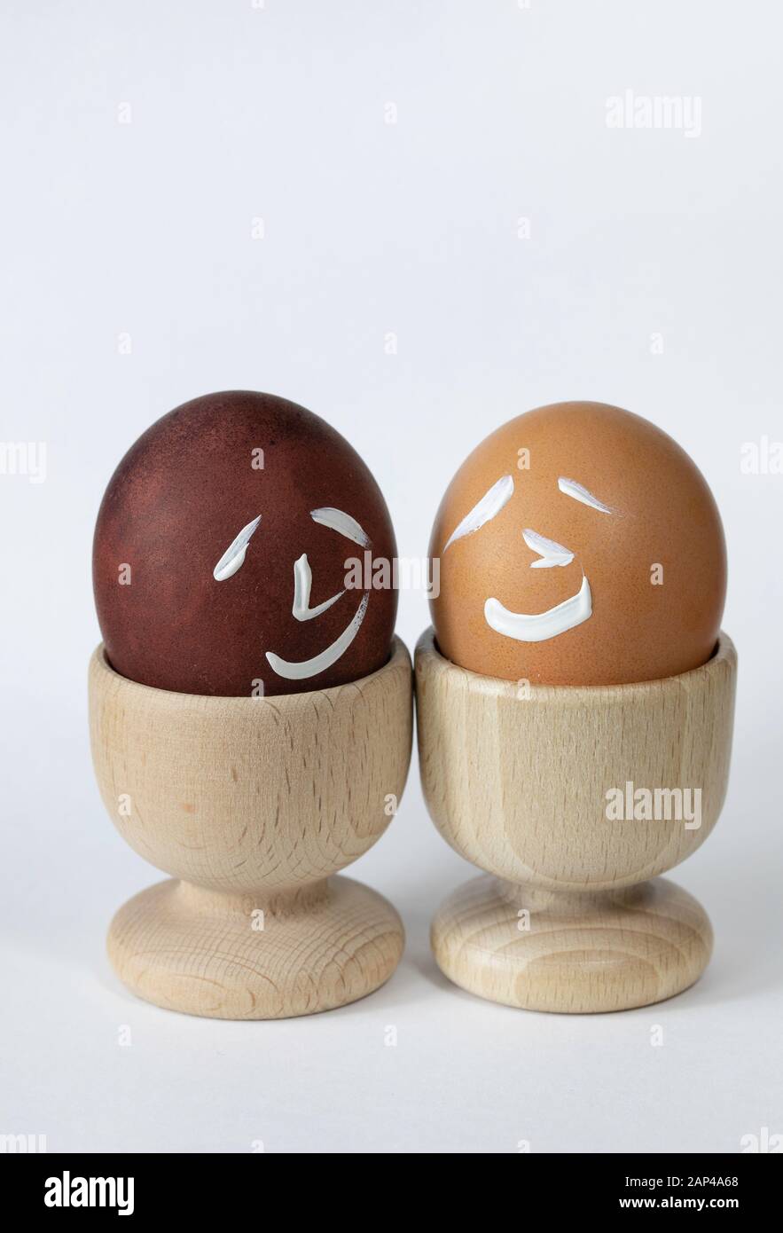 Painted and raw eggs. Funny drawings on eggshells. Easter artistic decoration. Stock Photo