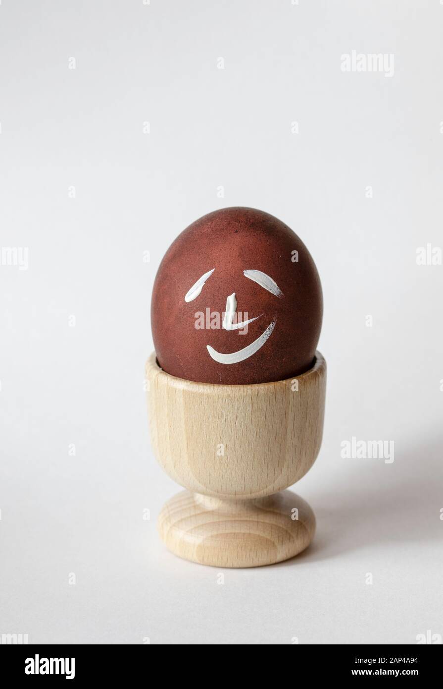 Painted and raw eggs. Funny drawings on eggshells. Easter artistic decoration. Stock Photo