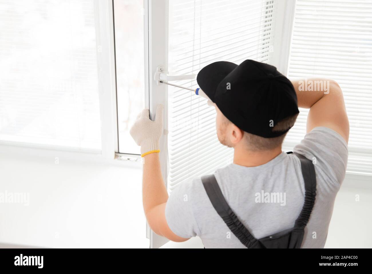 Construction worker man install plastic white upvc windows in house Stock Photo