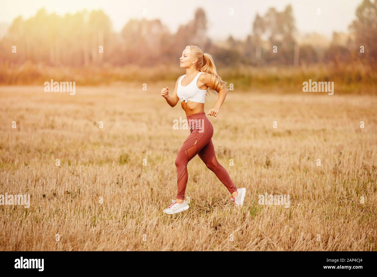 Athletic young blonde girl is jogging in park dawn, concept running for  health Stock Photo - Alamy
