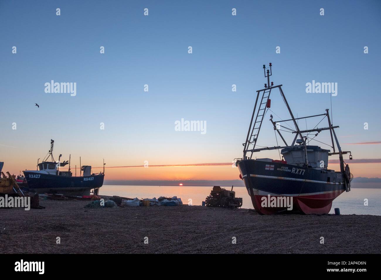 Hastings, East Sussex, UK. 21st January 2020. Sunrise on the Stade fishermen's beach, a cold start on a sunny day. Carolyn Clarke/Alamy Live News Stock Photo