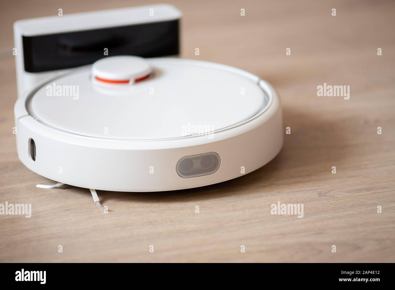 Robotic wireless smart vacuum cleaner working on laminate flooring