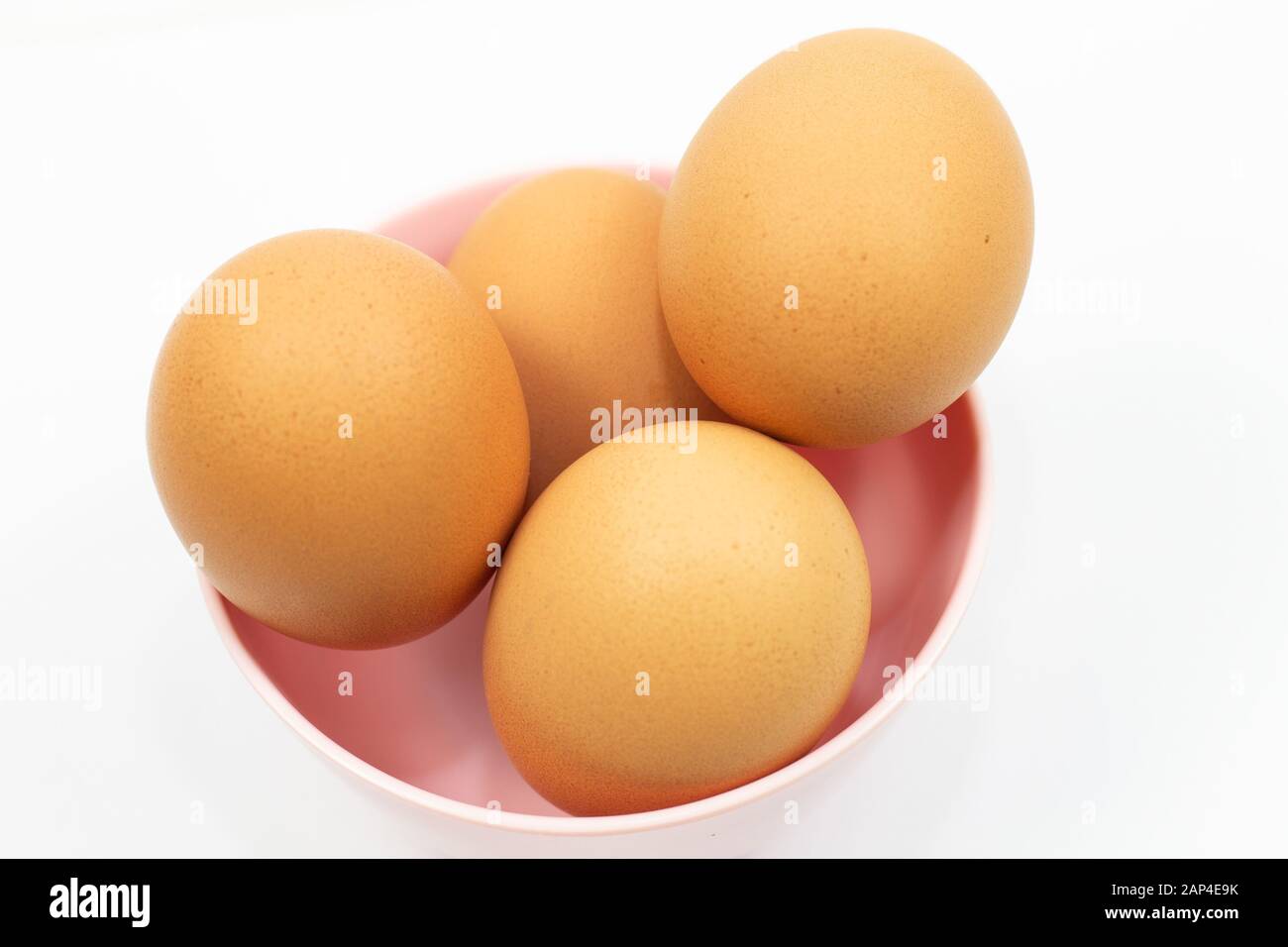 Eggs in bowl on white background. Stock Photo