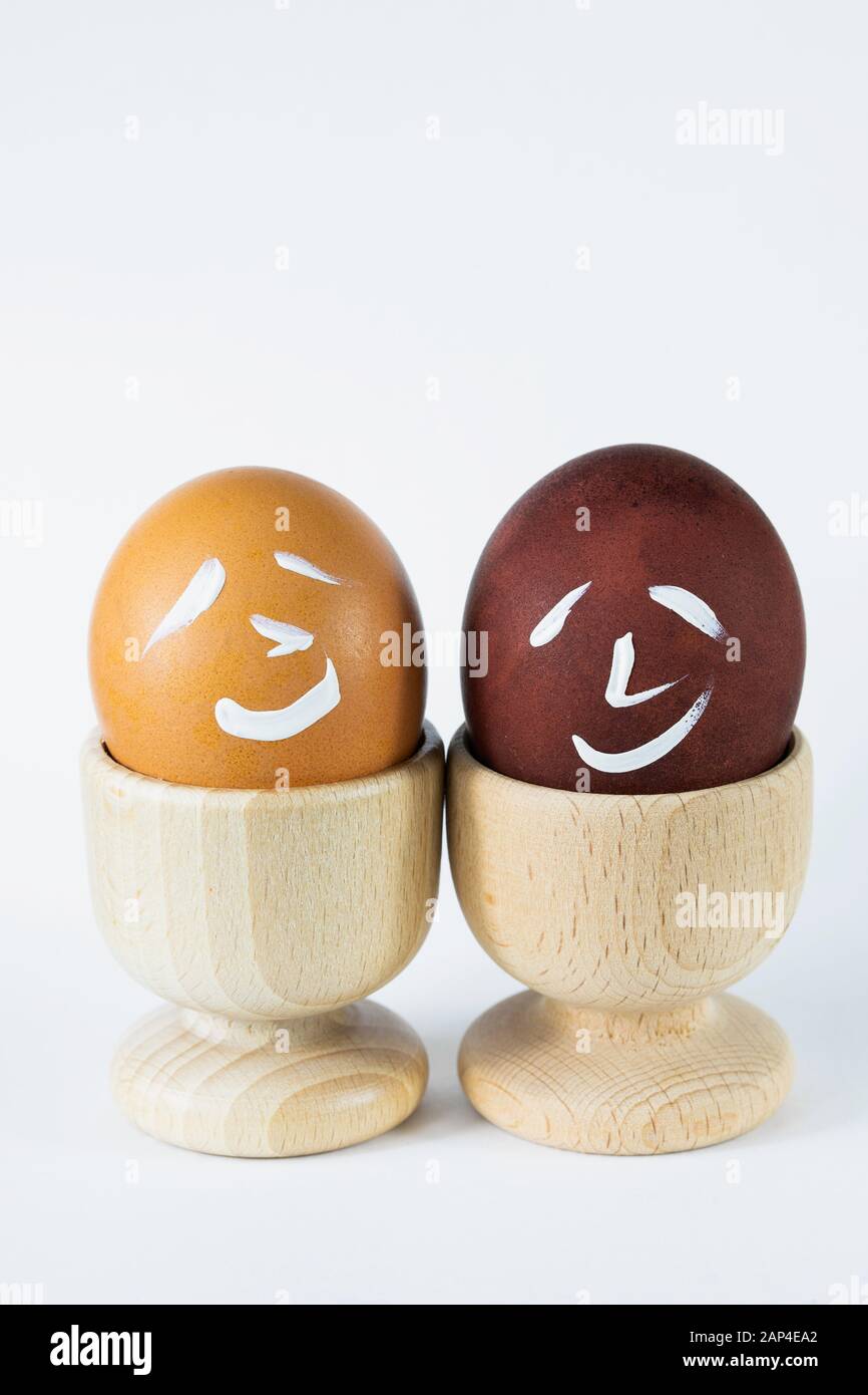 Painted and raw eggs. Funny drawings on eggshells. Easter artistic decoration. Stock Photo