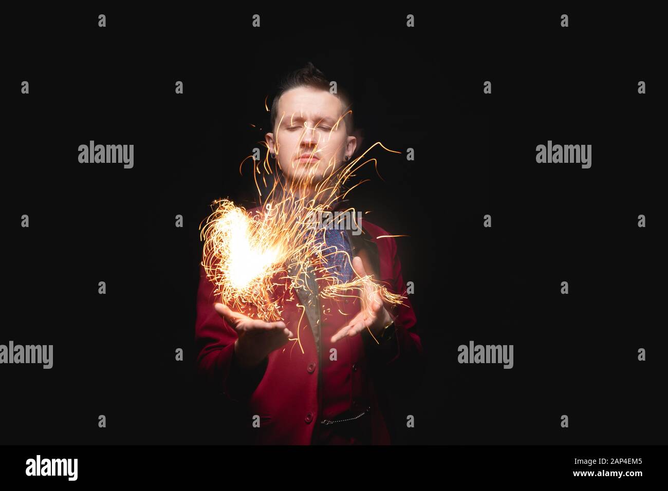 Magician shows trick with fire burn from palms hands Stock Photo Alamy