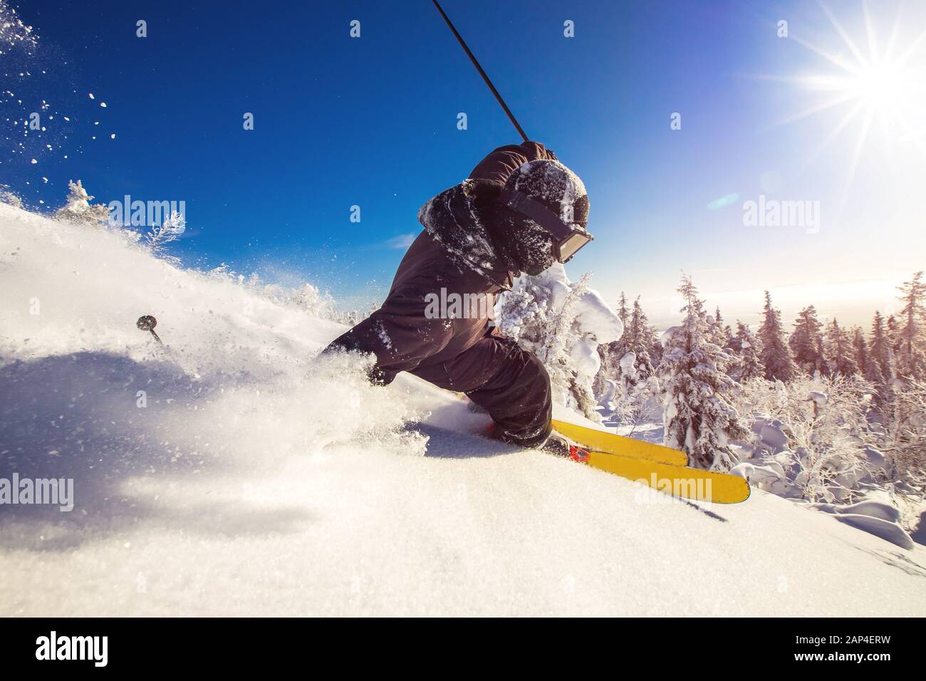 Skier skiing downhill during sunny day fresh snow freeride. Extreme