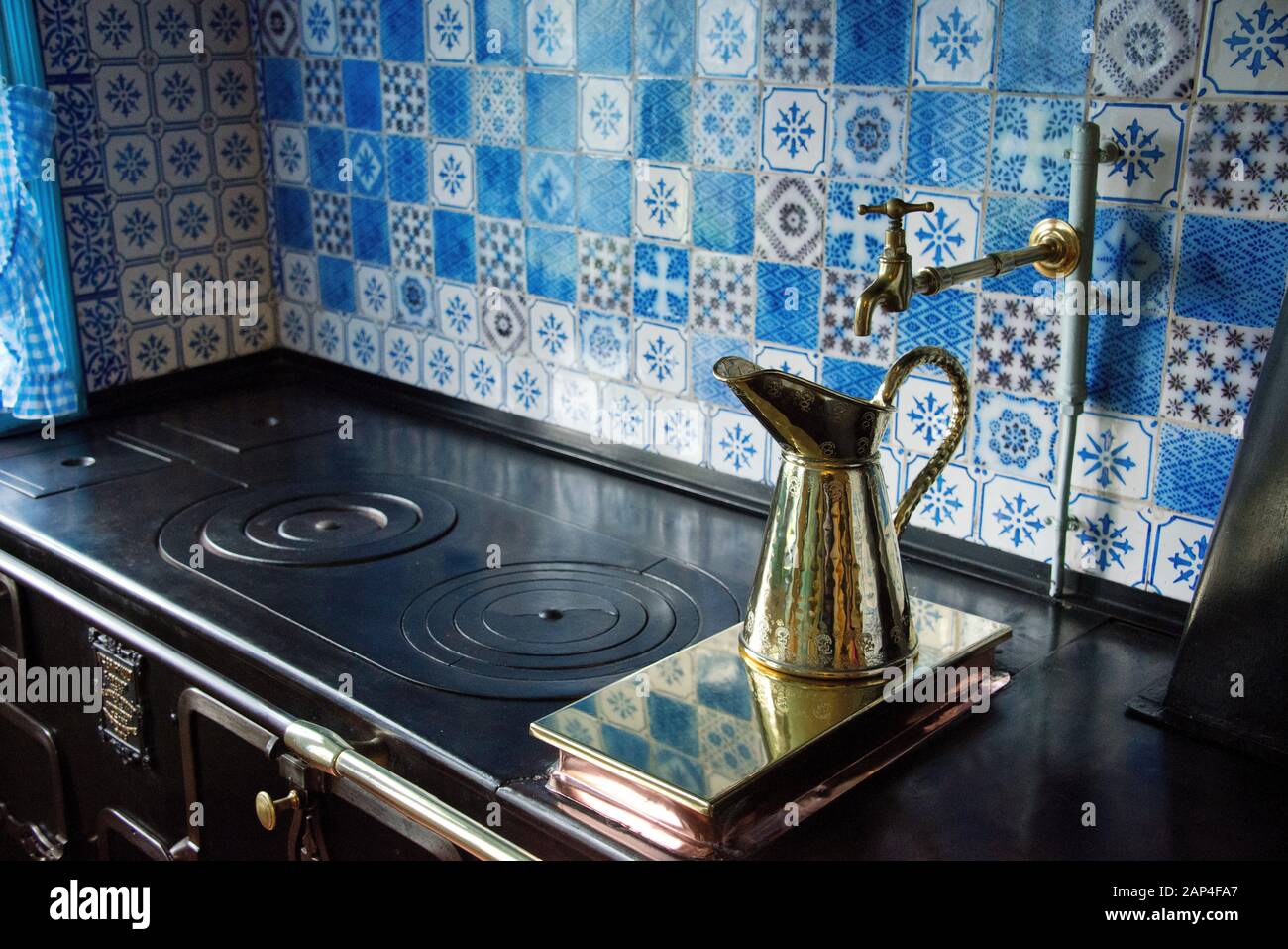 Claude Monet House Giverny Normandy France. Kitchen  area of House 84 Rue Claude Monet Giverny.  Monet House showing old cooking range with tap Stock Photo