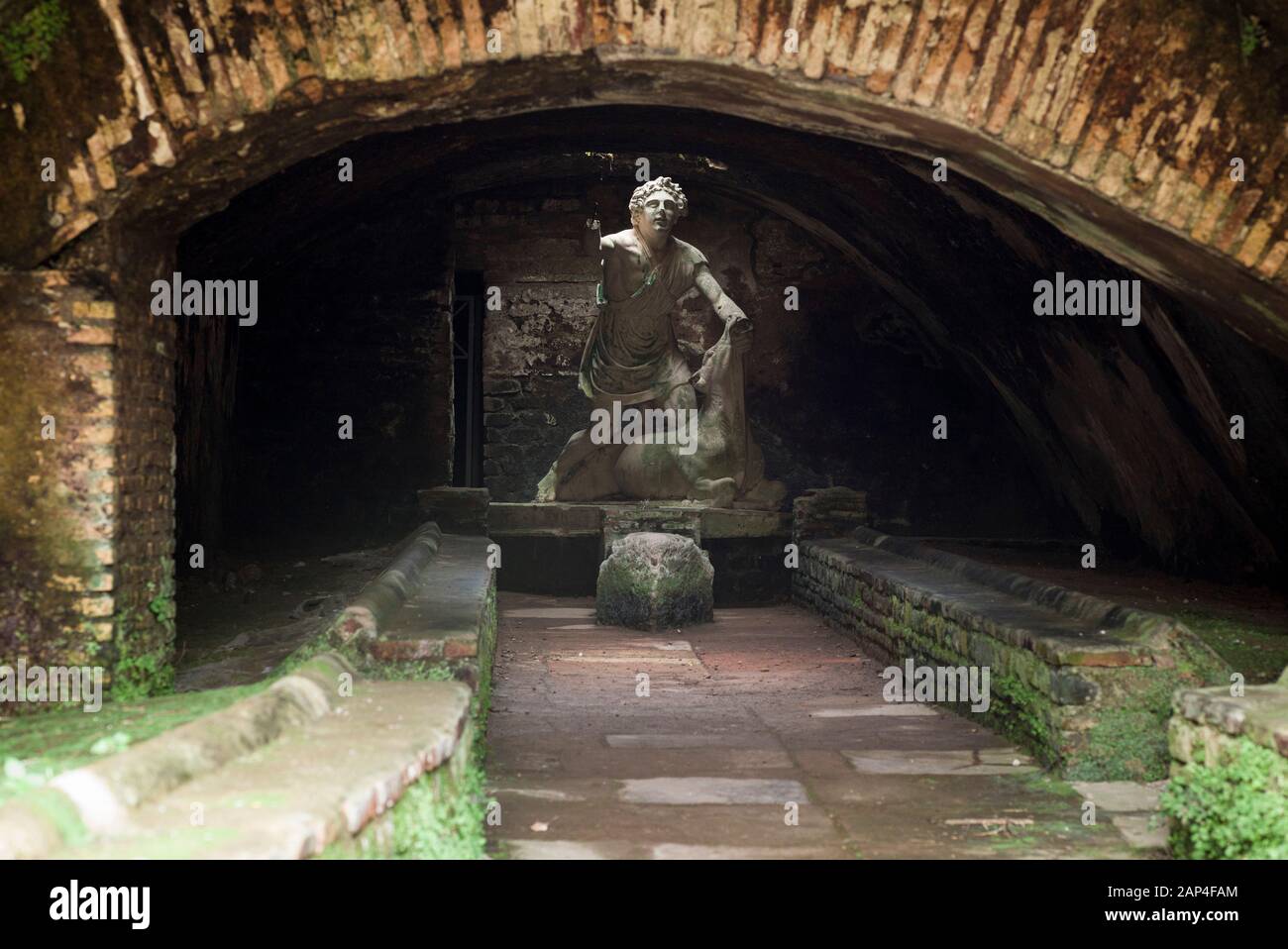 Rome. Italy. Ostia Antica. Mithraeum of the Baths of Mithras (Mitreo delle Terme del Mitra). Mithras about to kill the bull, cast of the original 1st Stock Photo